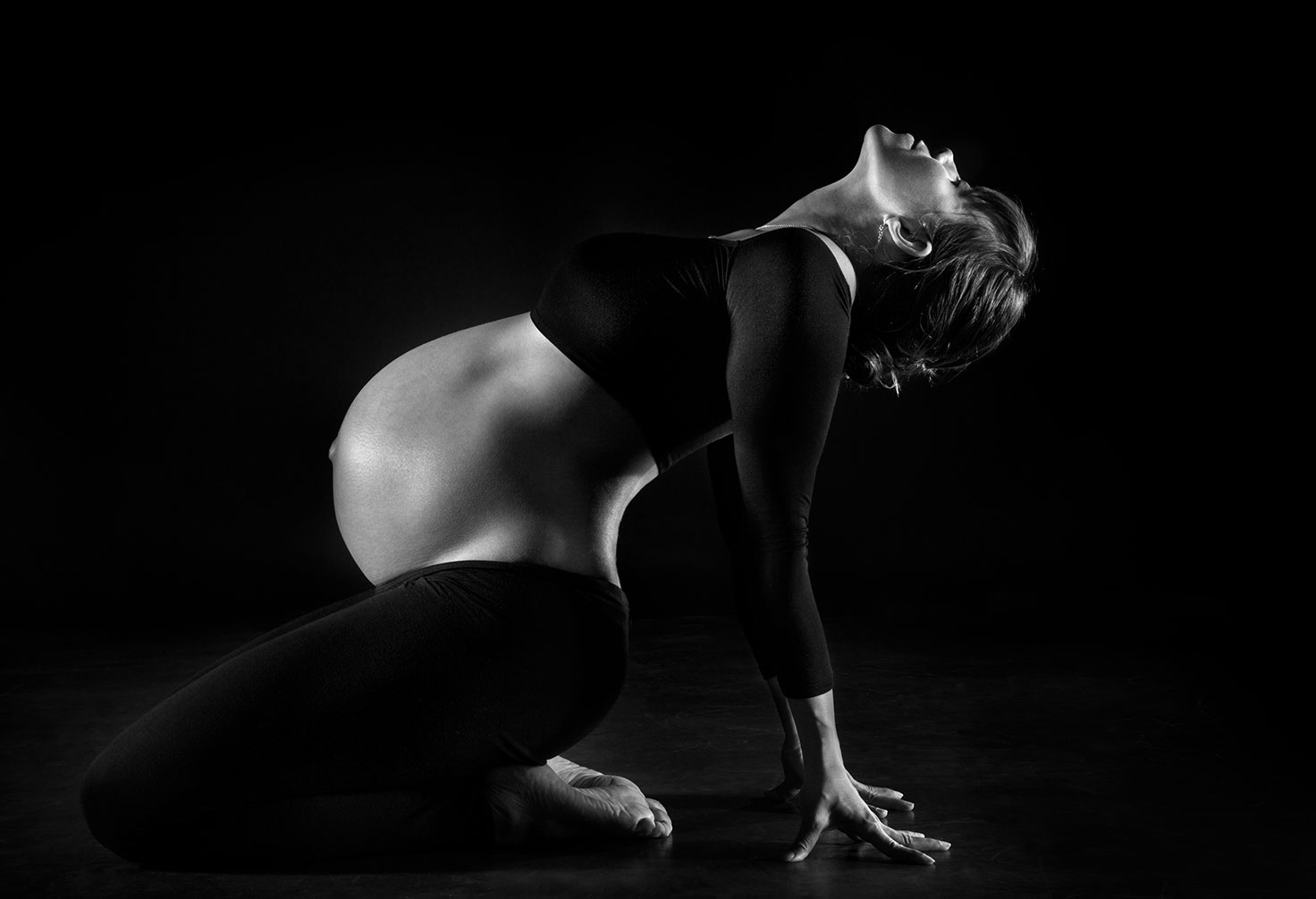 Pregnant woman performs yoga in the floor