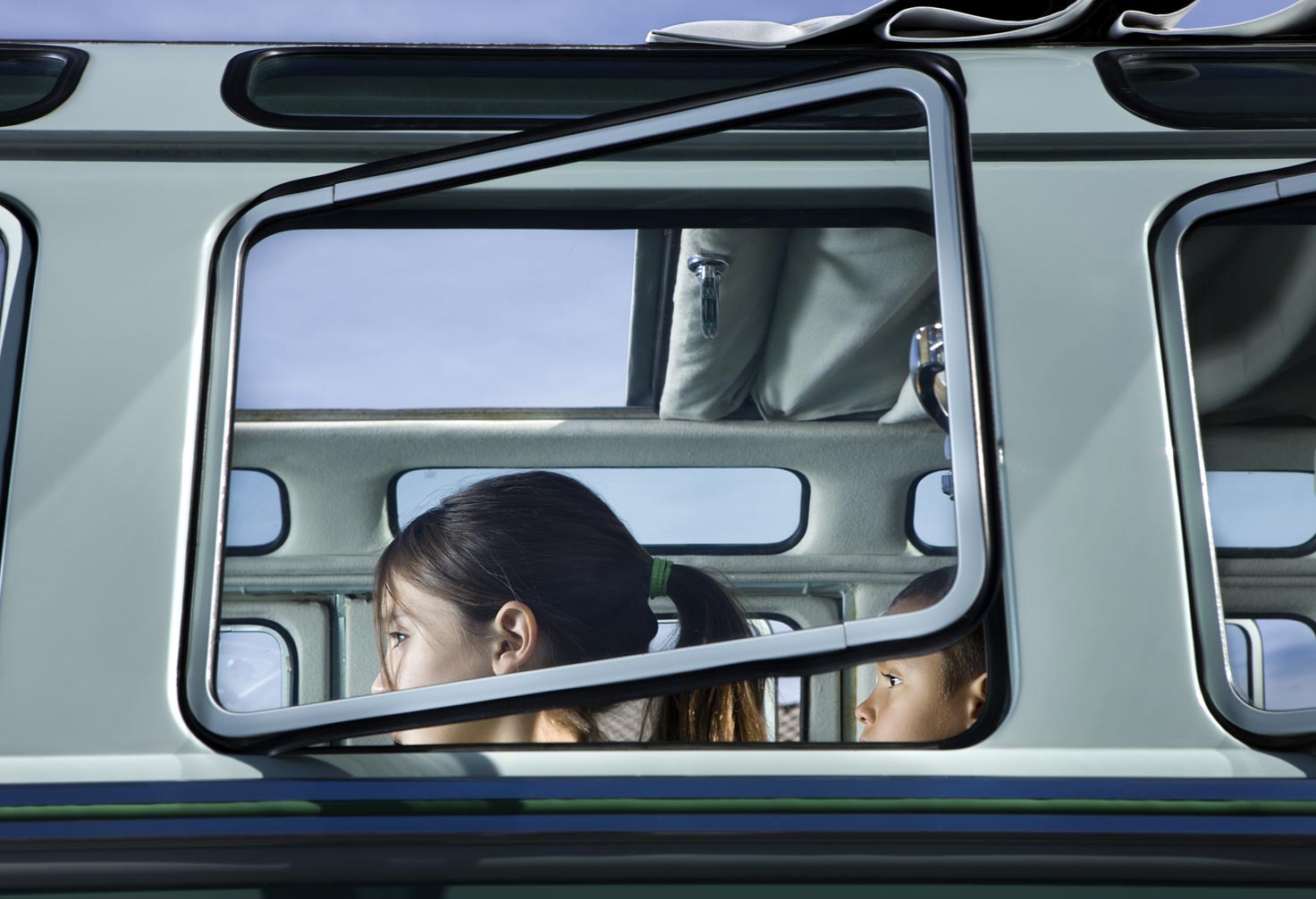 children sitting in car-view from outside windows